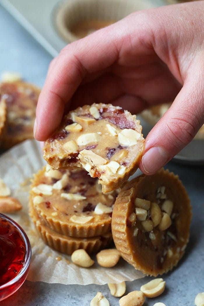 A hand holding a nut butter cup. 