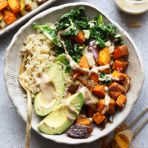 Buddha bowl with carrots, sweet potatoes, and avocado.