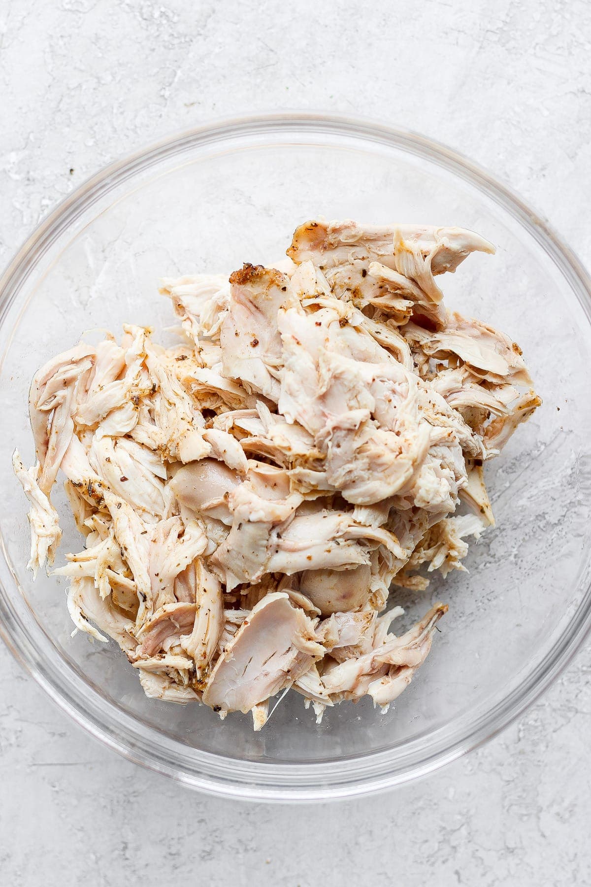 Plain shredded chicken in a bowl. 