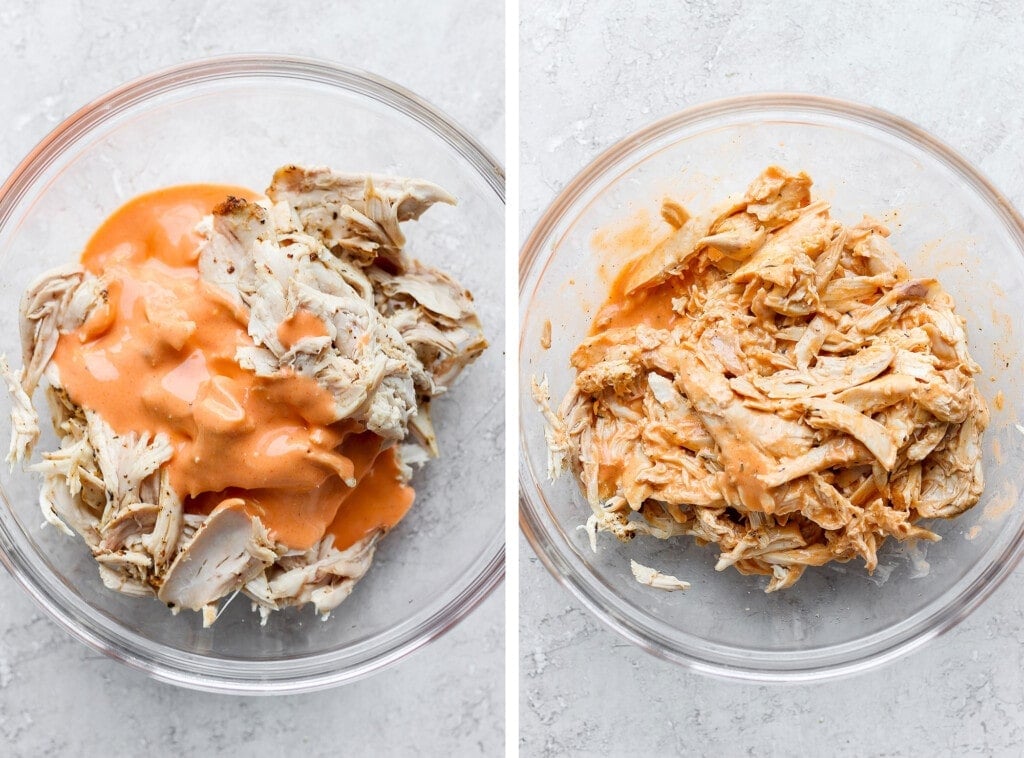 Shredded buffalo chicken being tossed with buffalo sauce.