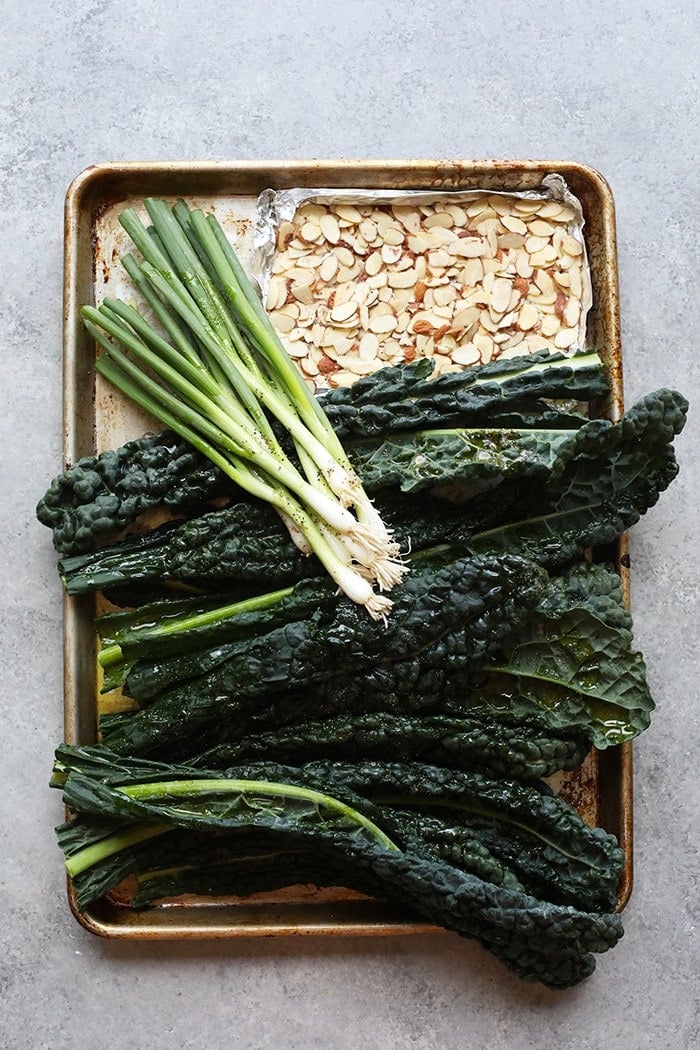 Cookie sheet with kale, green onions, and almonds