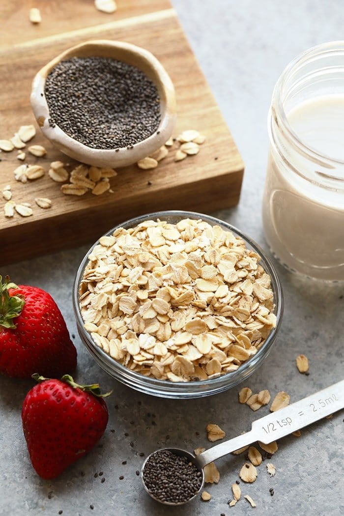 Overnight oats ingredients in bowls ready to be mixed together. 