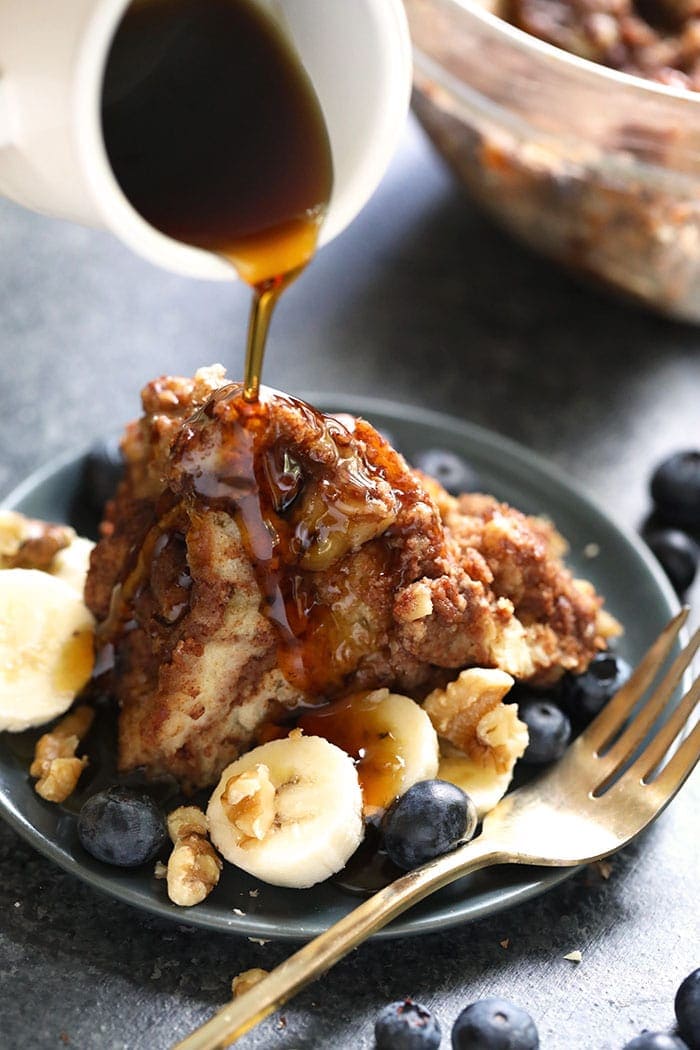 French Toast Casserole being drizzled with maple syrup 