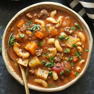 A bowl of hamburger soup with a fork.