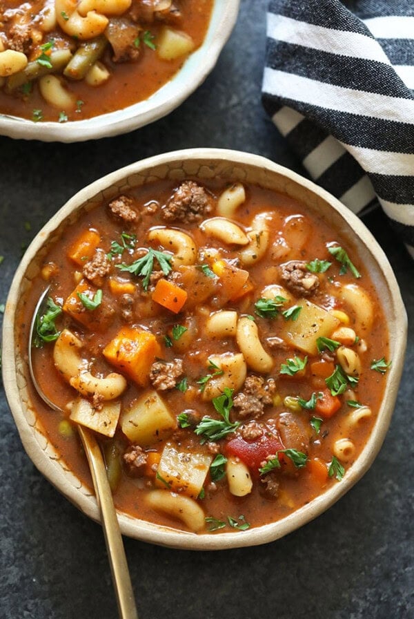 two bowls of hamburger soup on a table.