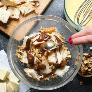 A person is mixing ingredients in a bowl.