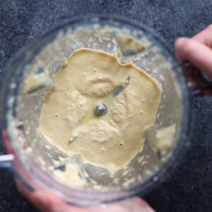 vegan person mixing a dough for mac and cheese in a bowl.