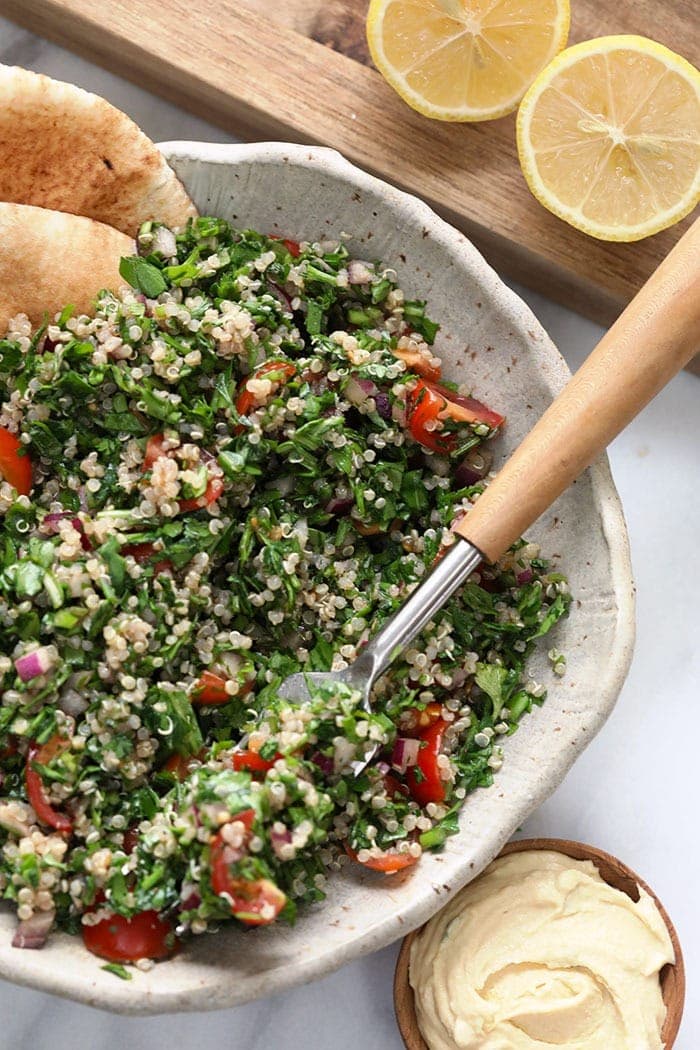 Taking a bite of a quinoa tabouli. 