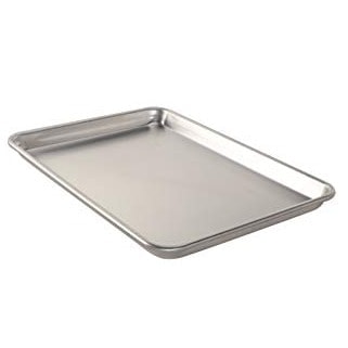 a stainless steel baking tray with shortbread and almond flour cookies on a white background.