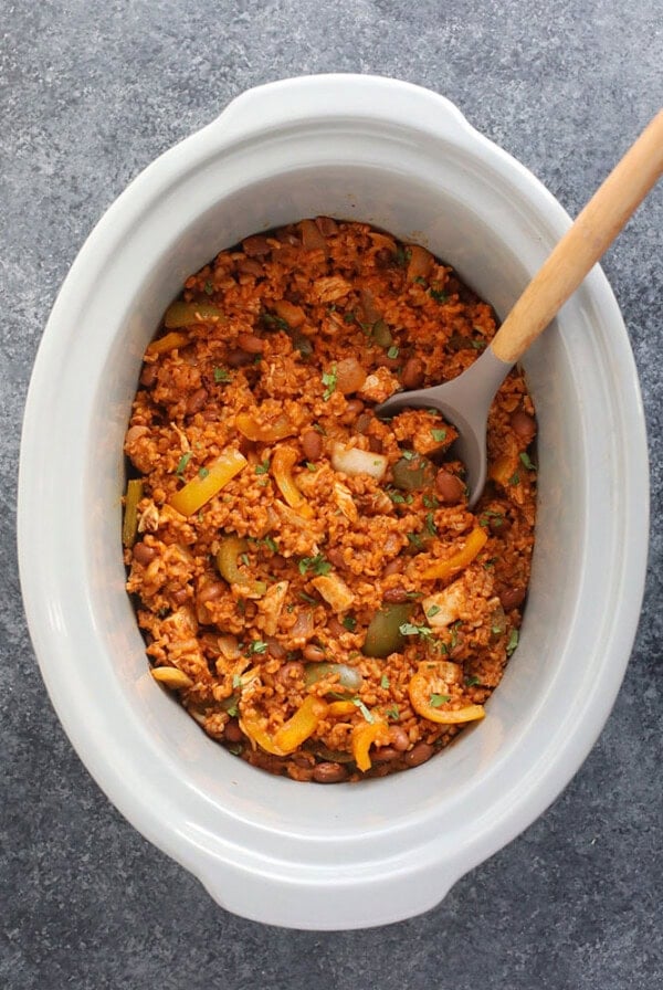 Slow cooker chicken enchilada casserole in a slow cooker.