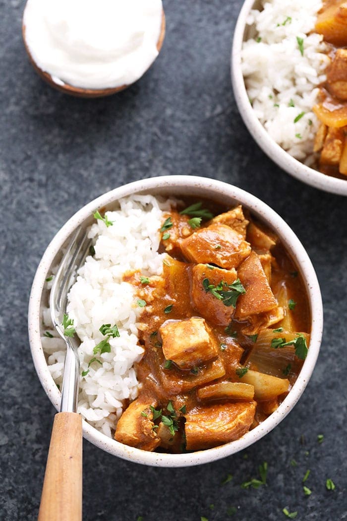 slow cooker healthy chicken tikka masala in a bowl with rice