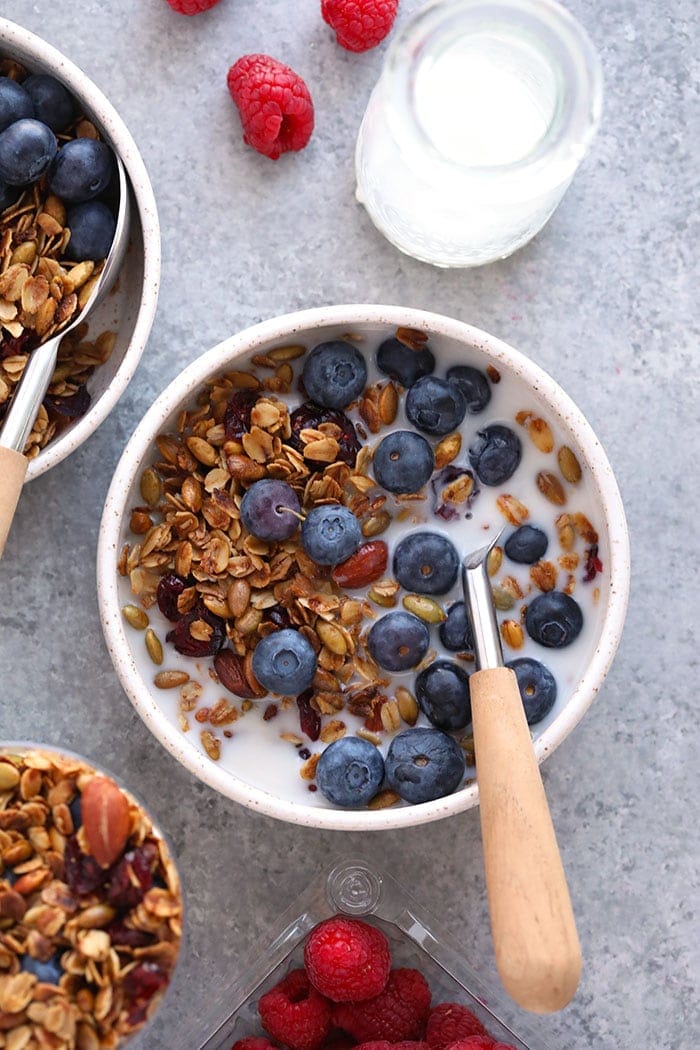 Healthy granola in a bowl with blueberries and milk.