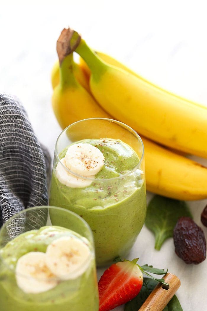 Green smoothies topped with bananas and flax