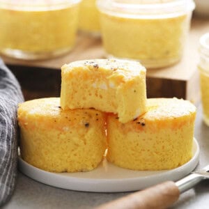 a plate with a stack of mini corn muffins and a fork.