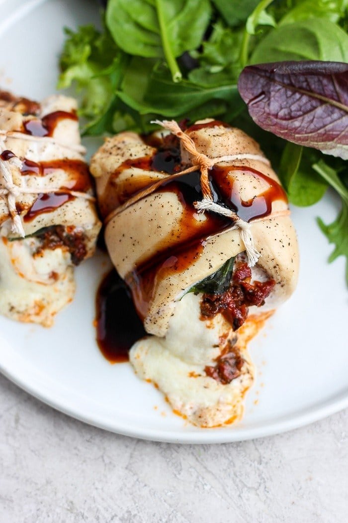 caprese stuffed chicken breast served on a plate