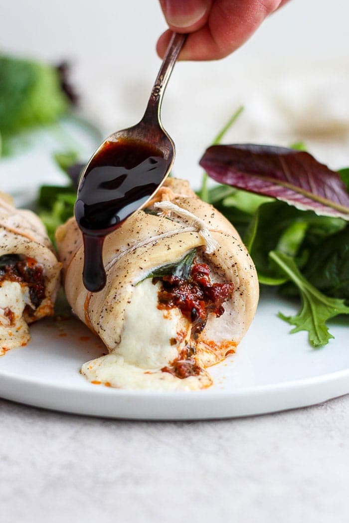 Caprese stuffed chicken breast drizzled with balsamic glaze.