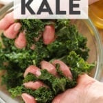 Two hands massaging kale