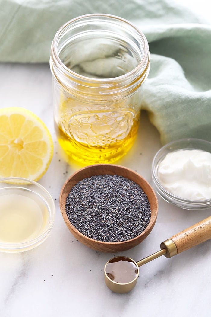 Ingredients for homemade poppy seed dressing in small bowls. 