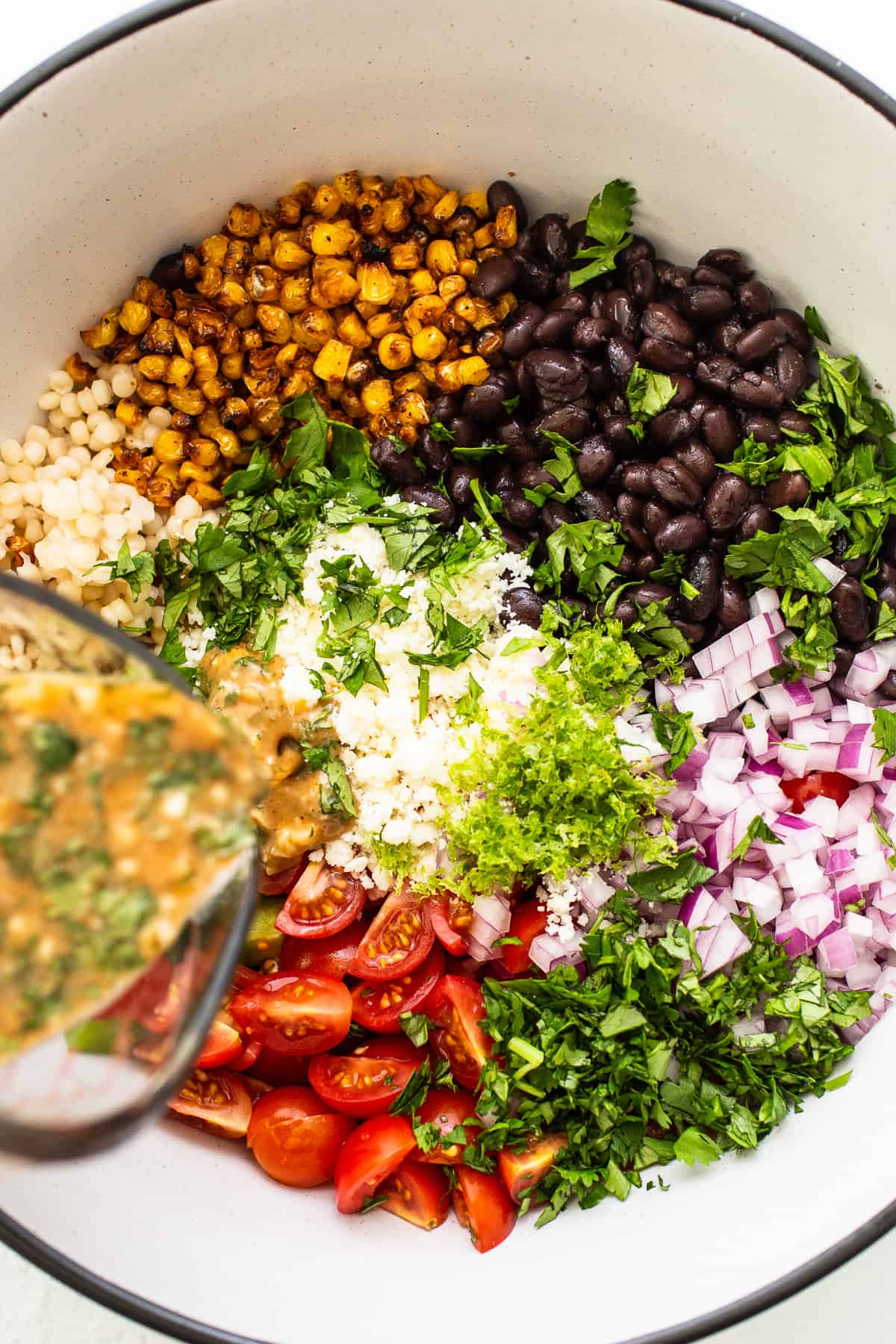 pouring dressing on salad.