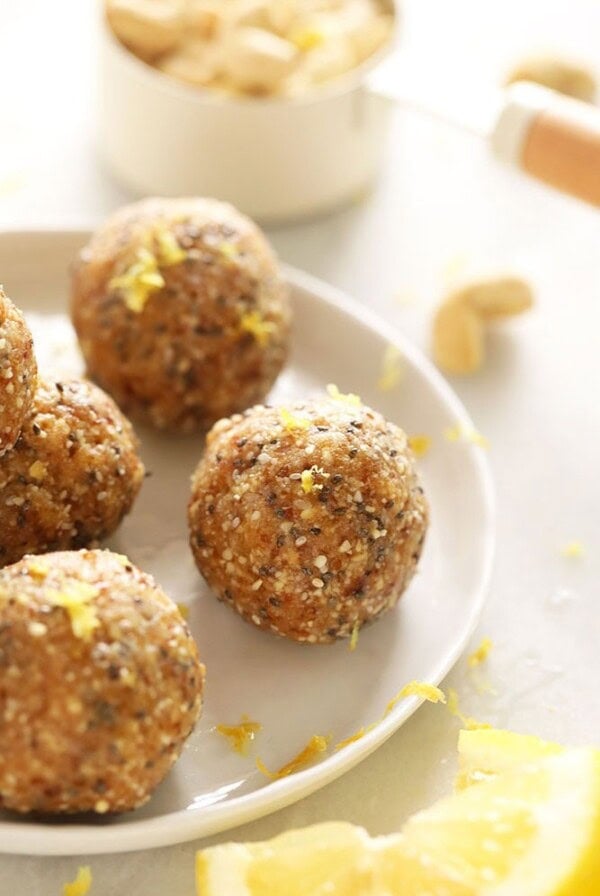 Lemon energy balls on a white plate.