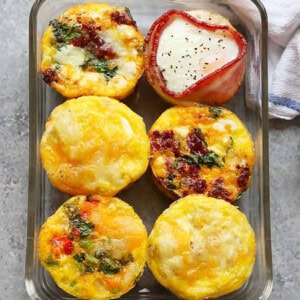 Breakfast egg cups baked in a glass dish.