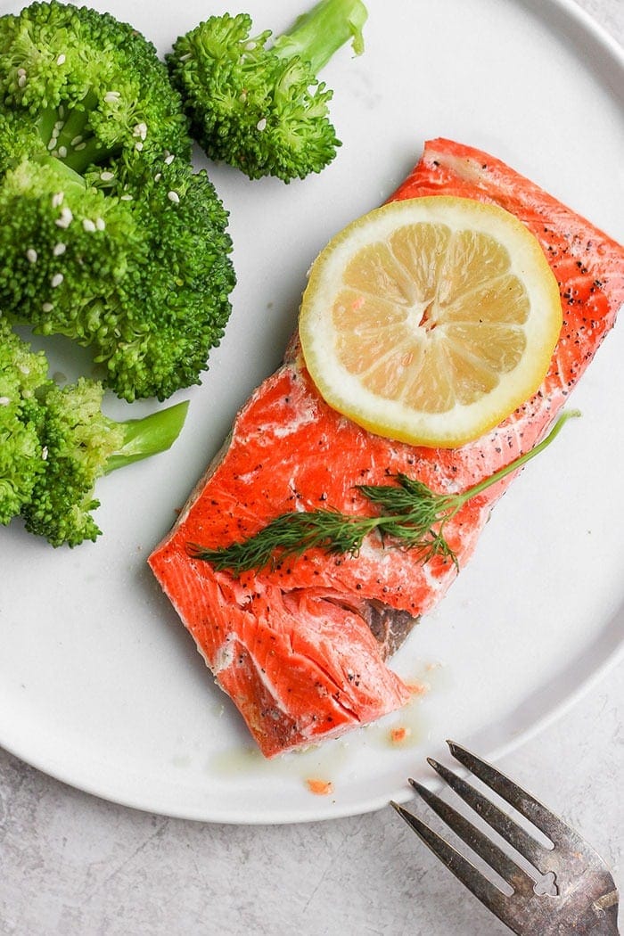 sous vide salmon on a plate with a side of broccoli