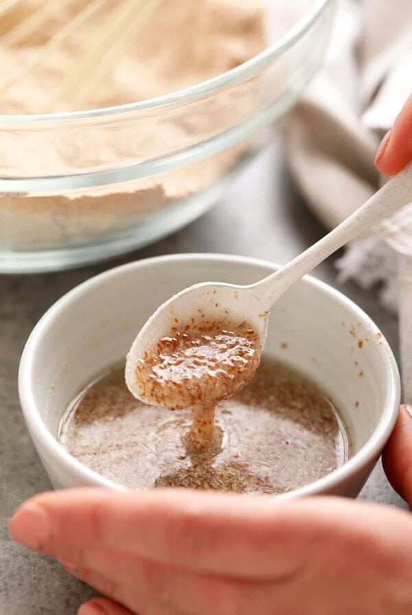 a person pouring flax egg into a bowl.