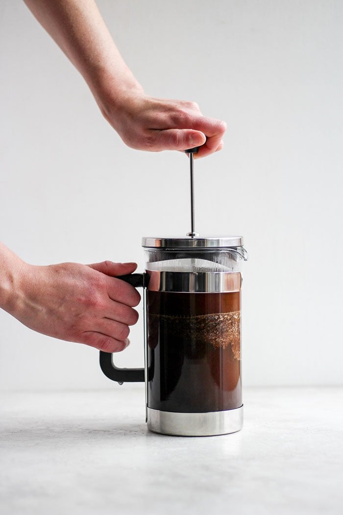 A pot of French press coffee brewing.