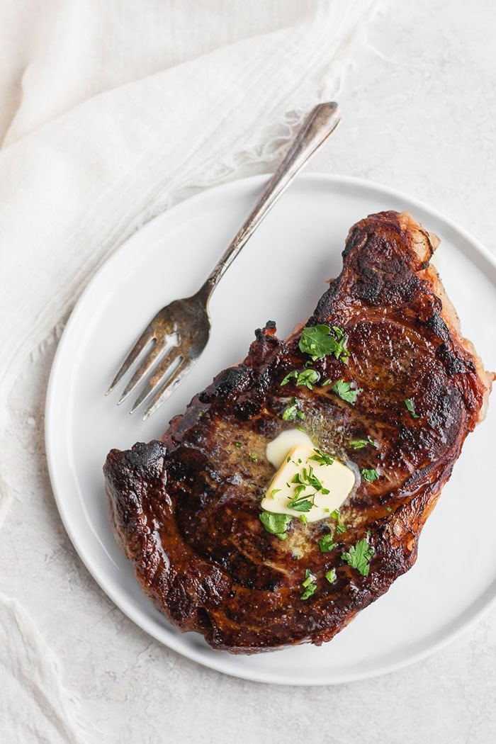 Sous vide steak with butter and fresh parsley on top. 