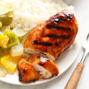 a plate with grilled chicken and vegetables on it.