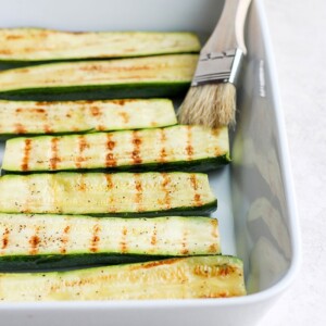 grilled zucchini in casserole dish.