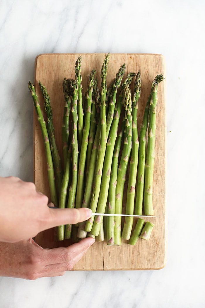 cutting asparagus with knife.