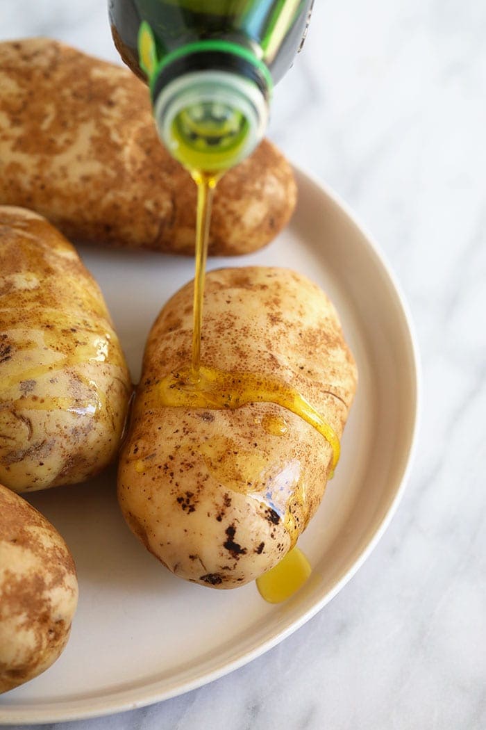 olive oil drizzling on baked potatoes