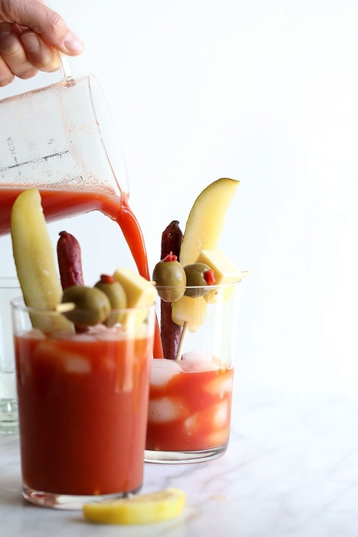 Pouring Bloody Mary Mix into a glass