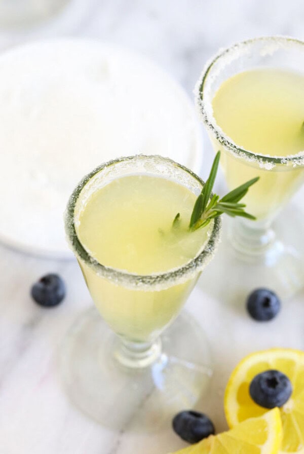 lemon drop margaritas with rosemary sprigs.