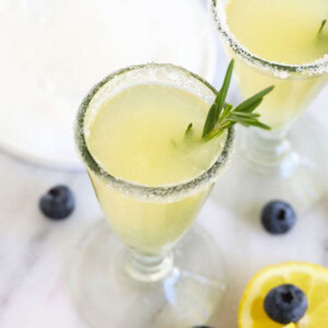 Lemonade with a hint of rosemary and a garnish of blueberries.