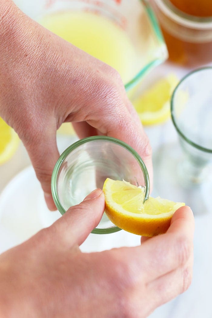 putting lemon juice on a martini glass rim