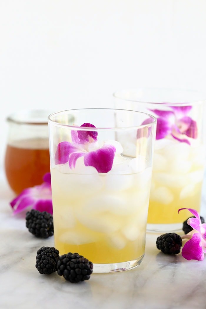 arnold palmer drink in a glass before pouring hibiscus tea over the top