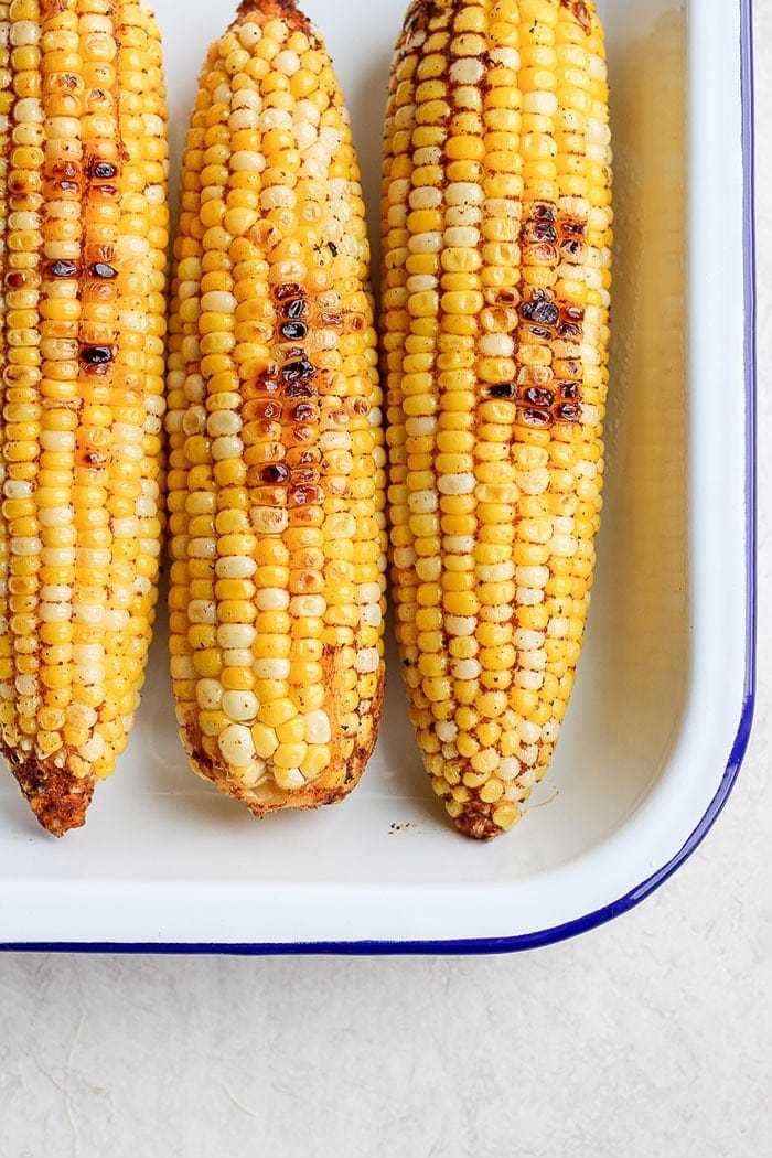 Grilled Mexican corn with chili powder.