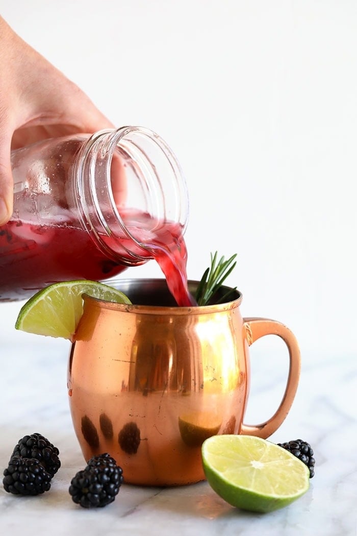 pouring moscow mule into cup