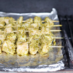 pesto chicken skewers on tin foil.