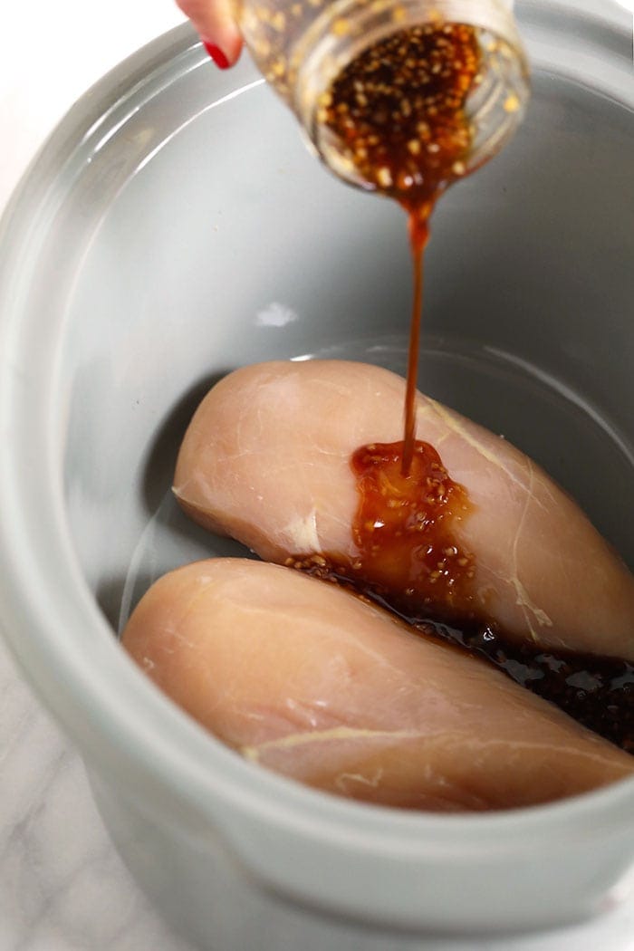 teriyaki sauce pouring onto chicken 