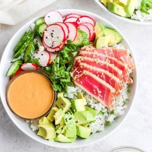 ahi tuna salad with arugula, served with a dipping sauce.