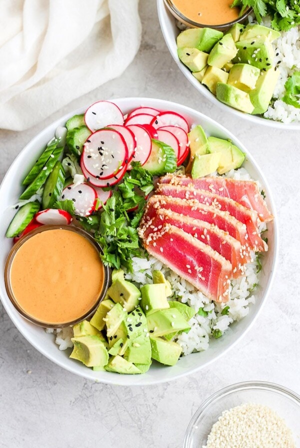 Ahi poke bowl with avocado, radish, and sesame seeds.