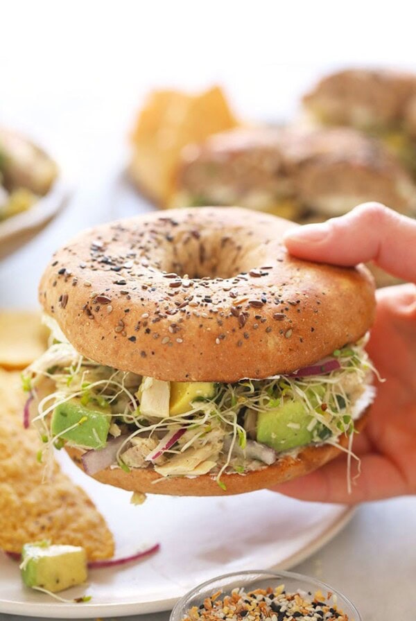 avocado tuna salad sandwich on an everything bagel