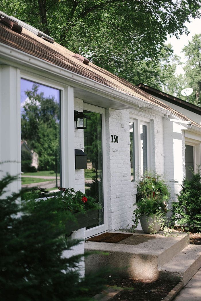 white brick house with black numbers