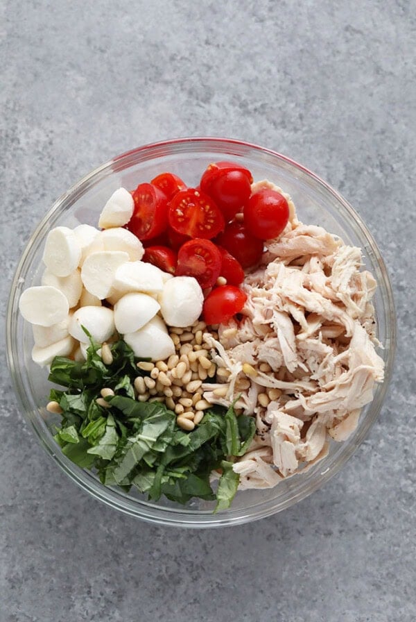 Ingredients for the pesto chicken salad in a bowl.