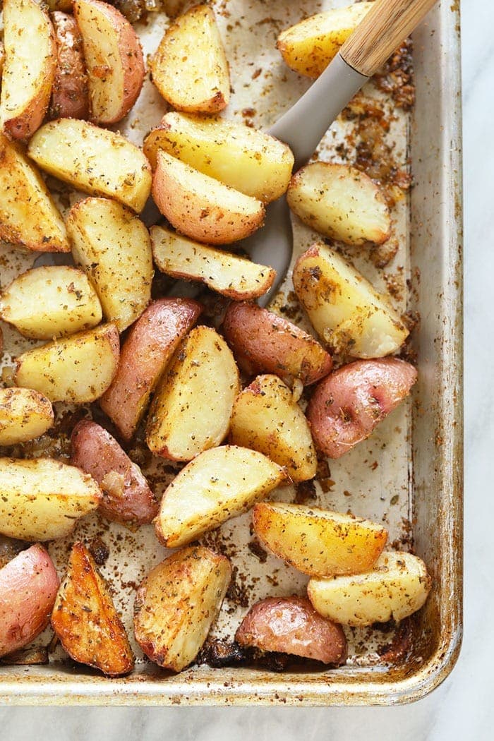 Tossing red potatoes on a pan