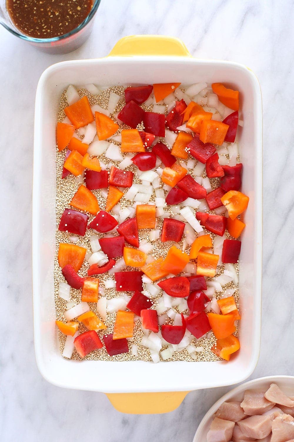 quinoa, peppers, and onion in casserole dish