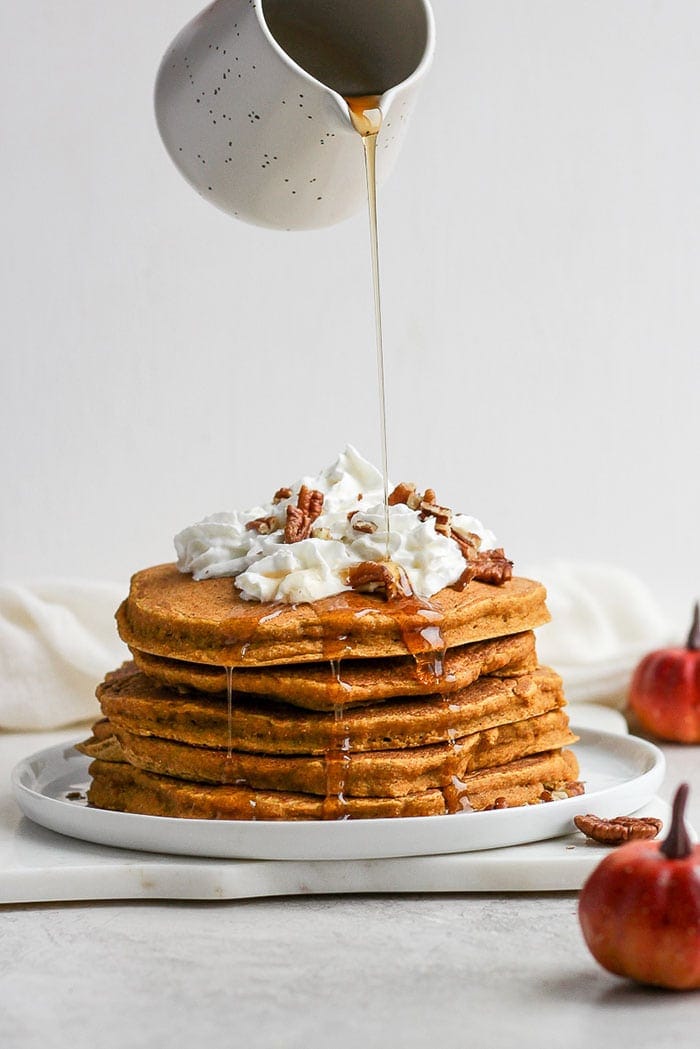 pouring syrup on pumpkin pancakes.